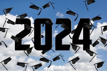 Airborne black graduation caps for 2024 in sky with white clouds 
