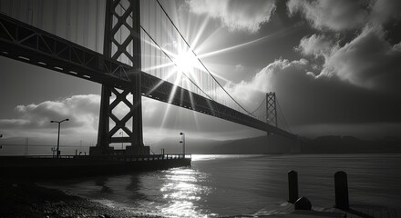 Sunburst streams through the structure of a bridge in a black and white photograph, creating a striking interplay of light and shadows. - Powered by Adobe