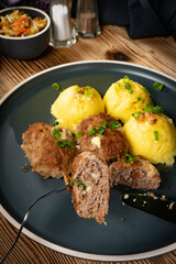 Meatballs with cheese served with boiled potatoes.