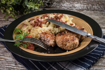Minced meat cutlets with boiled sauerkraut.