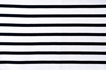 Texture of knitted fabric, cotton. Striped white and black textile background.