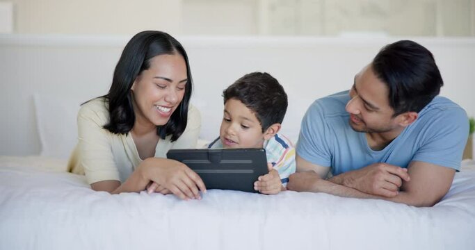 Tablet, laughing and child with parents on bed watching video, movie or show on the internet. Happy, bonding and boy kid with mother and father streaming film on digital technology in bedroom at home