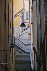 Romantic backstreet, side street or alley in historic old town of Genoa, Italy with historic...