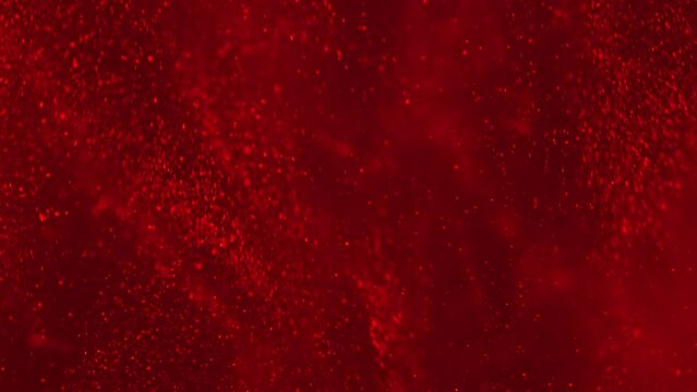 White luminous particles shimmer in blue liquid. Abstract digital particle wave and light abstract background. Floating particals in ocean. 