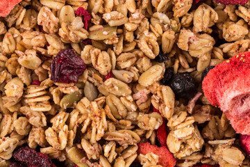 Muesli oat cereals close up background with dry fruits