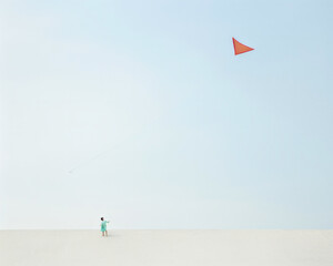 Little girl having fun flying a colorful kite on a beautiful sandy beach on a sunny day