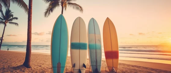 Fotobehang Surfboards on a sandy beach with palm trees in the background. Surfboards on the beach. Vacation Concept with Copy Space. © John Martin