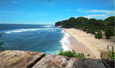 Photo of a very beautiful landscape of Drini Beach and Drini Hill in blue shades, one of the favorite tourist destinations in Yogyakarta, Indonesia