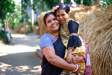 Smiling portrait of a south asian hindu religious mother and daughter , family togetherness concept 