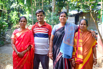 Portrait of south asian middle aged family members standing in a park wearing traditional costumes 