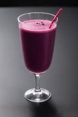 grape and black currant smoothie in transparent glass front view on dark background closeup. Selective focus	