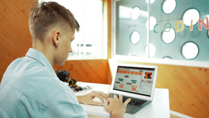 Back view of highschool student working on laptop analysis data at STEM science class. Smart happy...