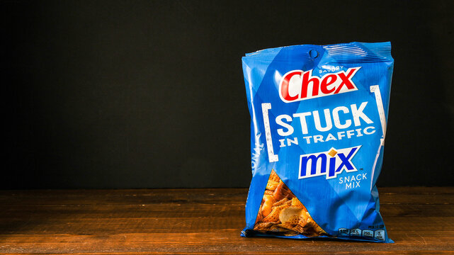 NORWALK, CT, USA - FEBRUARY 1, 2024: Chex mix snack package on wooden table and black background