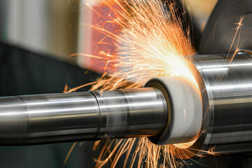 Sparks from the grinding wheel during internal grinding on a cylindrical grinding machine. - obrazy, fototapety, plakaty