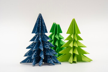 Three christmas trees made of blue and green paper