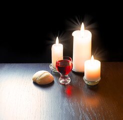 A bowl of wine and bread on the table. Communion symbols