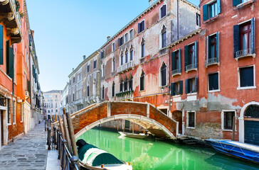 Fototapeta na wymiar Traditional canal with boats and colorful facades of old houses in Venice, Italy.