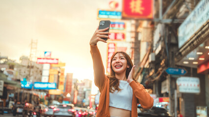 Happy young Asian tourist woman selfie by mobile smartphone, Female traveller taking photo of...