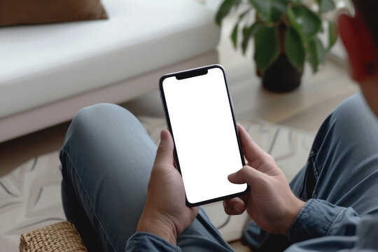 man using smartphone blank screen device while sitting on sofa at home