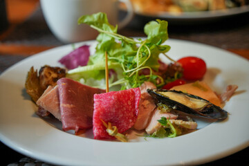 A delicious Western meal featuring sliced ham, a fresh salad, and gourmet sides, perfect for a savory dining experience.