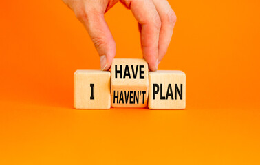 I have or not plan symbol. Concept word I have or have not plan on beautiful wooden cubes. Beautiful orange table orange background. Businessman hand. Business i have or not plan concept. Copy space.