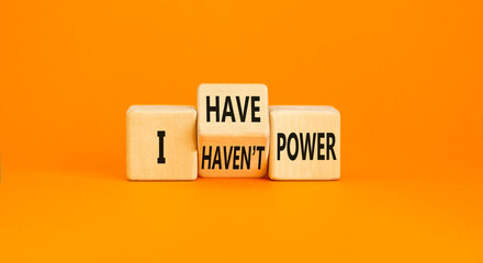 I have or not power symbol. Concept word I have or have not power on beautiful wooden cubes. Beautiful orange table orange background. Business and i have or not power concept. Copy space.