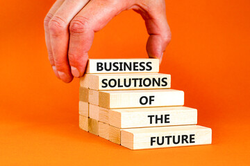 Business solutions of the future symbol. Concept words Business solutions of the future on wooden blocks. Beautiful orange table orange background. Business solutions of the future concept. Copy space