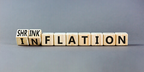 Inflation or shrinkflation symbol. Concept words Inflation Shrinkflation on beautiful wooden...