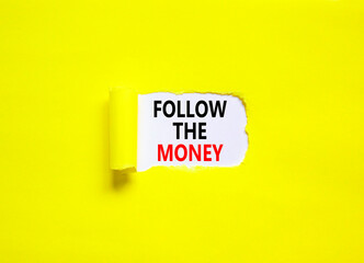 Follow the money symbol. Concept words Follow the money on beautiful white paper. Beautiful yellow paper background. Business and follow the money concept. Copy space.