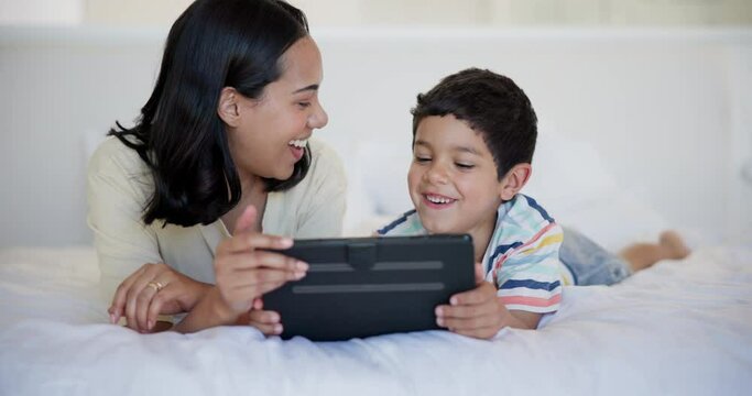 Tablet, happy and child with mother on bed watching video, movie or show on the internet. Smile, bonding and boy kid with young mom streaming film on digital technology in bedroom at family home.