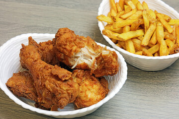 fried chicken in a basket with French fries.