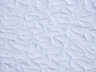 White plastered wall background, irregular stroke shapes
