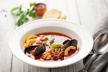 French seafood bouillabaisse soup with mussels, prawns, octopus and fish.