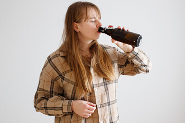 woman drinks beer. alcoholism. bad habits