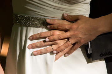 Detail of the hands and the ring of a newlywed couple in spring forest in La Fageda d en Jorda, La Garrotxa, Spain