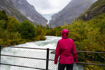 Fototapeta na wymiar Young women in Briksdal glacier valley in south Norway, Europe