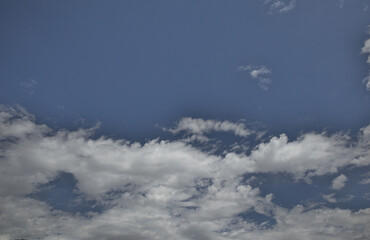 Naklejka na ściany i meble Stratocumulus clouds background in blue sky.
