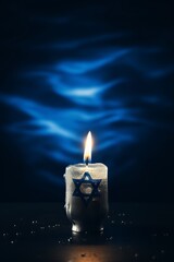 burning candle on the flag of Israel on a dark background