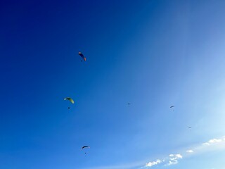 PHOTOGRAPH OF PARAGLIDERS FLYING FROM THE CHALCHIHUAPAN HILL, PUEBLA, MEXICO