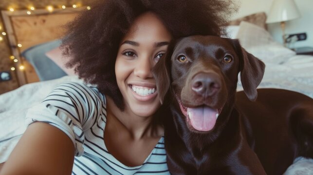 Smiling african americane young girl with lovely dog taking selfie in a hotel room. Pet friendly hotel, friendship, relax, social media profile picture and memory, influencer, pet owner 