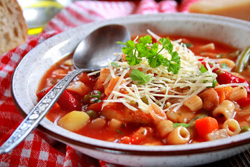 Minestrone soup with pasta and vegetables. Italian food. Selective focus.
