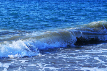 Obraz premium Beautiful Seascape. Turbulent the sea. Vacation and summer concept. Landscape. Powerful Ocean blue waves with white foam. Sea waves. Blue sea water background. Blue ocean background. Bubbling Sea wave
