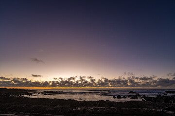 Sunrise on the Kaloko Beach in Honolulu Oahu Hawaii. wilight is light produced by sunlight scattering in the upper atmosphere, when the Sun is below the horizon, which illuminates the lower atmosphere