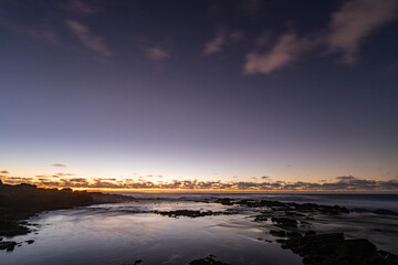 Sunrise on the Kaloko Beach in Honolulu Oahu Hawaii. wilight is light produced by sunlight...