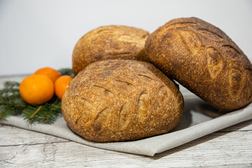 Baked bread. Bread on a table. Pattern on bread. Homemade bread. Crisp bread crust. Sourdough bread. Unleavened bread. Yeast-free bread. Bread baked at home.