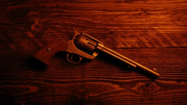 Wild West Gun On Table In Firelight
