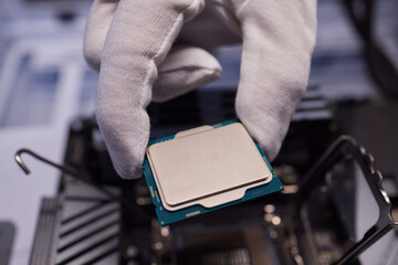 Cropped image of an engineer showing a computer microchip on the foreground