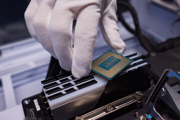 Cropped image of an engineer showing a computer microchip on the foreground