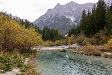 Fototapeta na wymiar Scenic view of river Weissbach (Rio Bianco) in panoramic valley Fischleintal, Moos, South Tyrol, Italy. Majestic rugged mountain ridges of wild Sexten Dolomites, Italian Alps. Wanderlust in wilderness