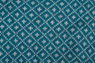 knitted blouse, with diamond shape pattern . abstract backdrop, close up texture